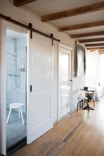 a room with a door and a table and a table at RiverSide Suite - Haarlem City Centre in Haarlem