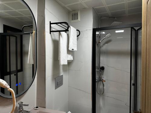 a bathroom with a shower and a mirror at Lokka Hotel Ortakoy in Istanbul