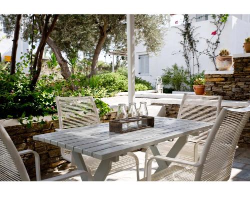 a wooden table and chairs on a patio at Verina Terra in Platis Gialos