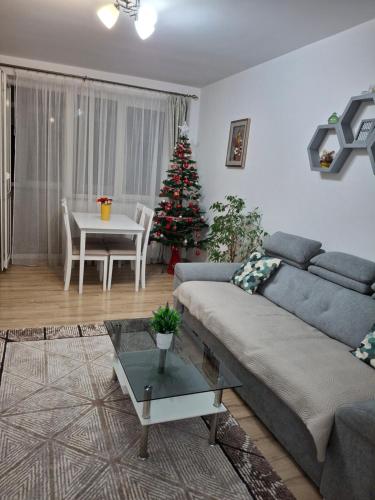 a living room with a couch and a christmas tree at Apartament Ultra Central Marly Gura Humorului in Gura Humorului