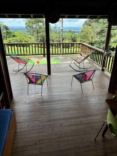a group of chairs sitting on a deck at Casa de Micos in Salinas de Cumaral