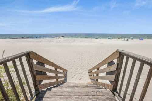 a wooden boardwalk leading to a beach with the ocean at Compass Point 201 Pet-friendly for fee Boat ramp in Gulf Shores