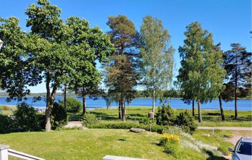 a park with a view of the water at Nice Home In Hökerum With Sauna in Hökerum