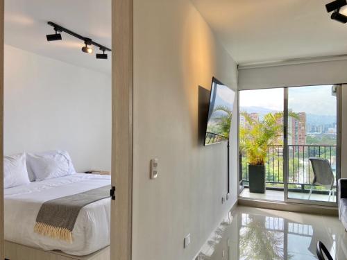 a bedroom with a bed and a balcony at Hotel Santa Ana Medellin in Medellín