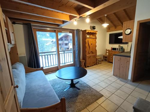 un salon avec une table et une cuisine dans l'établissement Studio confortable à Pralognan, proche patinoire et téléphérique - FR-1-464-192, à Pralognan-la-Vanoise