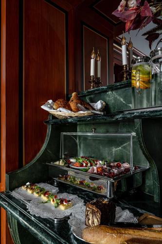 a buffet with several trays of food on display at La Chambre du Marais in Paris