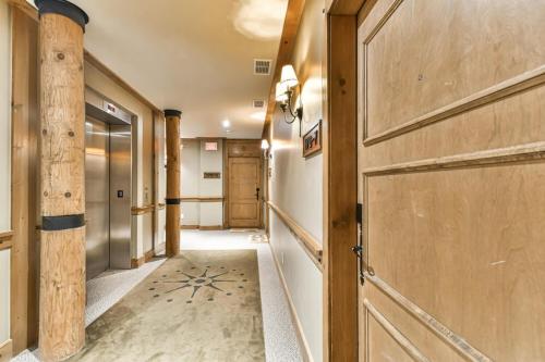 a hallway with a wooden door and a hallway with a hallway at Tremblant Prestige - Equinoxe 170-7 in Mont-Tremblant