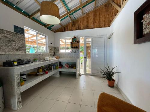 a kitchen with white tile floors and a ceiling at Cabaña sunrise view in Providencia