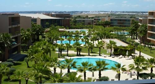 an aerial view of the resort with palm trees and a pool at Charming apartment Herdade dos Salgados - Vila das Lagoas T2 in Guia
