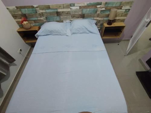 a large white bed in a small room at Residencia BB in Praia