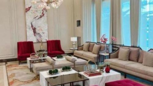 a living room with couches and a chandelier at CC Loft in Mandurriao