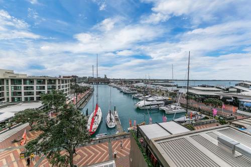 a marina with boats in the water and buildings at Luxurious & Spacious Living with Breathtaking Views in Auckland