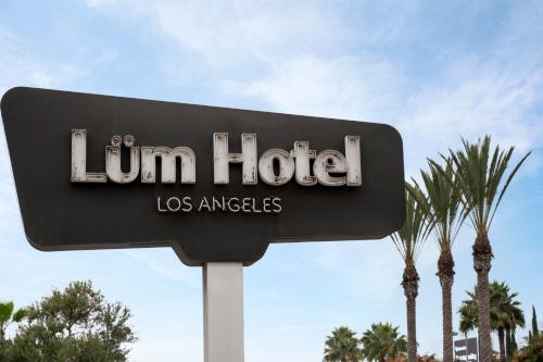 a sign for a lou ham hotel los angeles at The Lum Hotel Los Angeles Stadium District in Inglewood