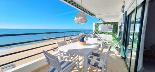 a dining room with a view of the ocean at Ocean Blue II in Quarteira