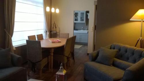 Una sala de estar con una mesa y sillas y un sofá. en Vacation Home Casa Fratelli, en Brujas