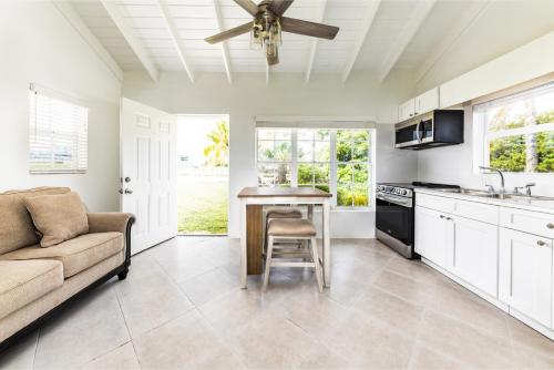 a kitchen with a couch and a ceiling fan at Tropical Bottle Creek Stay & Onsite Parking in NCA