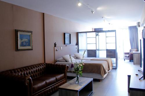 a hotel room with a bed and a couch at Rivadavia Apartment in Buenos Aires