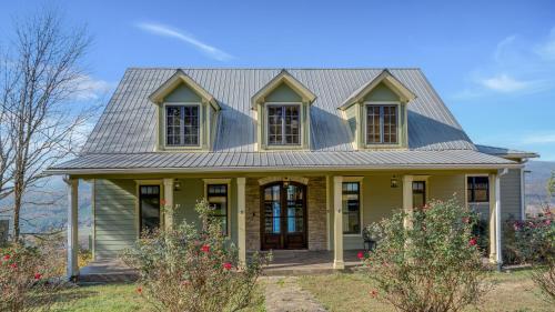 a yellow house with a metal roof at The Lodge in Mentone in Mentone
