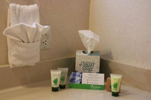 a box of aapsouri suit sitting on a counter with towels at My Place Suites in Wickenburg