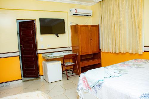 Ένα ή περισσότερα κρεβάτια σε δωμάτιο στο Hotel Jarumã