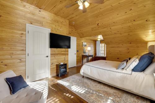 a bedroom with a bed and a flat screen tv at The Lodge in Mentone in Mentone