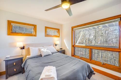 a bedroom with a bed and a large window at Deck, Fire Pit and Game Room Beech Mountain Retreat in Beech Mountain