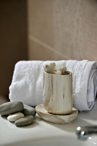 a toothbrush holder sitting on a table with towels at Villa Cat El in Isthmia