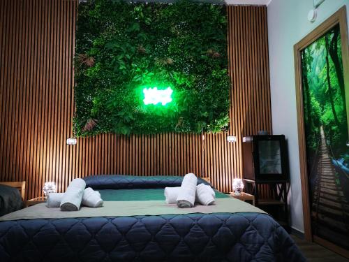 a bedroom with a bed with a green wall at B&B Tonnarella Beach in Torre Forte