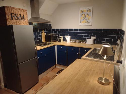 Kuchyň nebo kuchyňský kout v ubytování The Mews Cottage