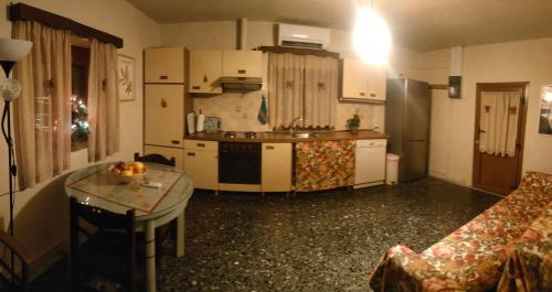 a kitchen with a couch and a table in a room at Stone Yard in Néa Karváli