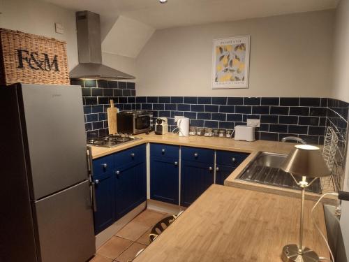 Kuchyň nebo kuchyňský kout v ubytování The Mews Cottage