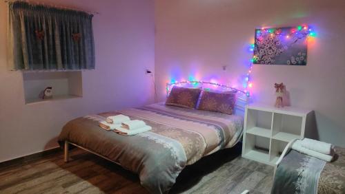 a bedroom with a bed with lights on it at Stone Yard in Néa Karváli