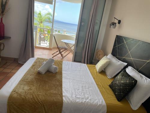 une chambre avec un lit avec vue sur l'océan dans l'établissement Studio mya evasion 219 tartane martinique, à La Trinité