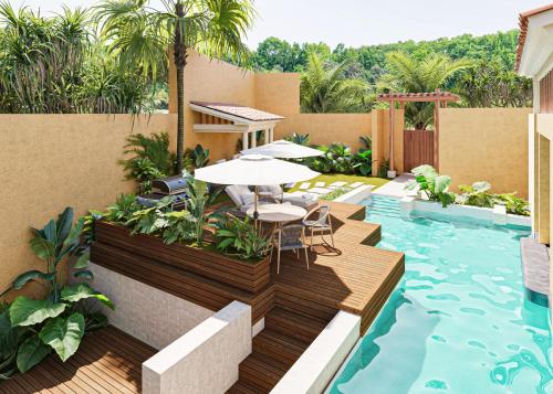 a patio with a table and chairs next to a swimming pool at Banyan Tree Mayakoba in Playa del Carmen