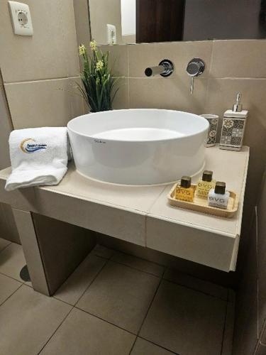 a bathroom with a large white sink on a counter at Charming apartment Herdade dos Salgados - Vila das Lagoas T2 in Guia