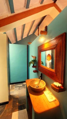 a bathroom with a sink and a mirror on a counter at Samaria Lodge in Sainte Marie