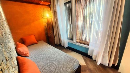 a small bedroom with a bed and a window at Samaria Lodge in Sainte Marie