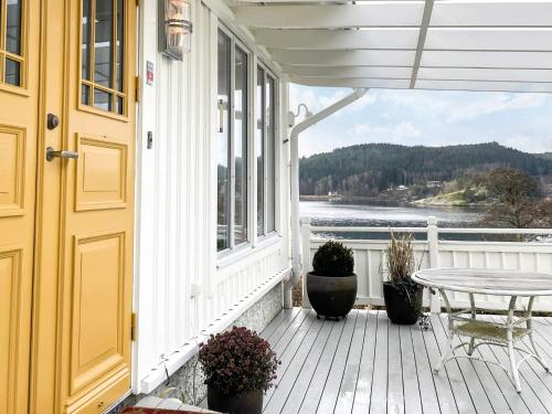 a porch with a table and a view of the water at 5 star holiday home in Uddevalla in Sundsandvik