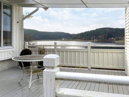 a porch with a table and a view of the water at 5 star holiday home in Uddevalla in Sundsandvik