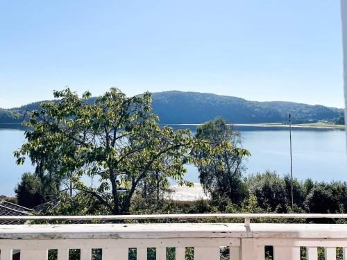 a tree in front of a body of water at 5 star holiday home in Uddevalla in Sundsandvik