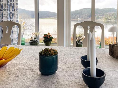 a table with a candle and some plants on it at 5 star holiday home in Uddevalla in Sundsandvik