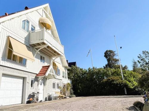 a white building with a balcony on the side of it at 5 star holiday home in Uddevalla in Sundsandvik