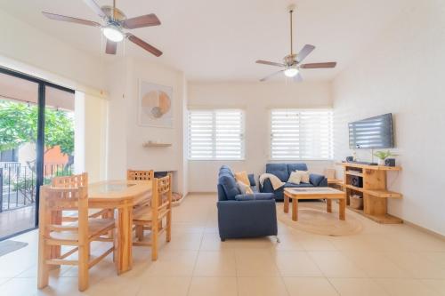 a living room with a table and a dining room at GoBaja Villas 3 bedroom in La Paz