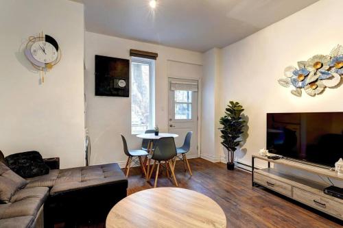 a living room with a couch and a table at Le Magnifique - Close by Downtown in Montréal