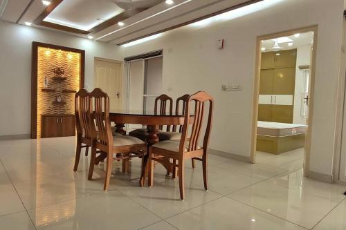 a dining room table and chairs in a room at 2 Bedroom River view apartment in Aluva, near Cochin Airport in Alwaye
