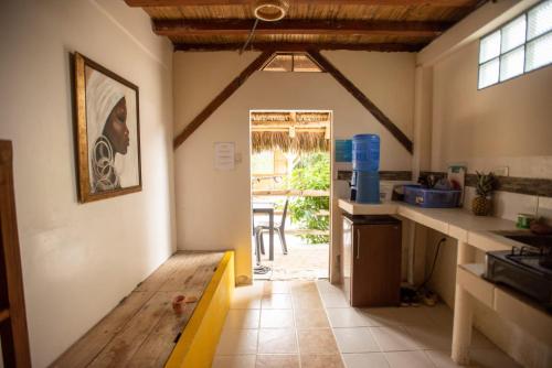 a kitchen with a door leading to a patio at La Casa Mompiche in Mompiche