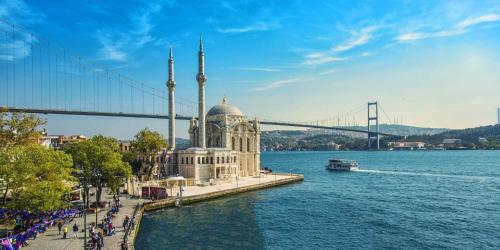 a large building on the water next to a bridge at Santa Rio Gold Taxim Hotel in Istanbul