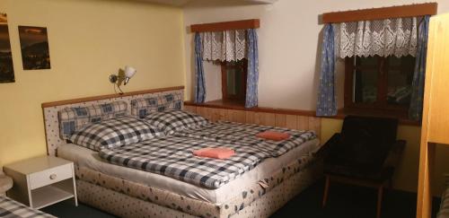 a bedroom with a bed and a chair in it at Chalupa Jestřebí in Velké Svatoňovice