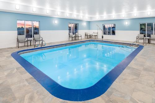 a large pool with blue water in a building at Holiday Inn Express Hotel & Suites Cheyenne by IHG in Cheyenne
