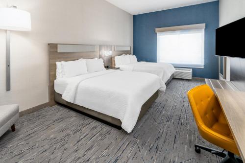 a hotel room with two beds and a window at Holiday Inn Express Hotel & Suites Cheyenne by IHG in Cheyenne
